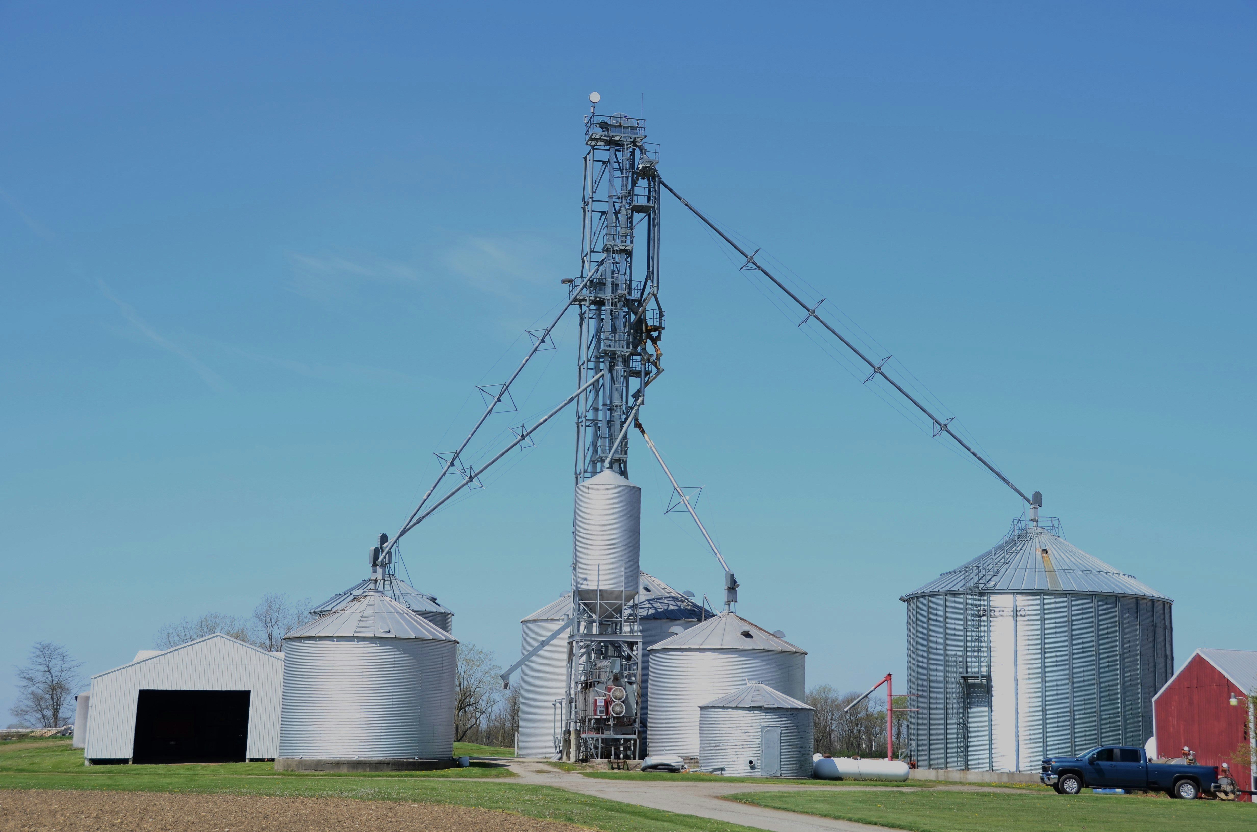 Family farm grain bin yard with bucket elevator automation system