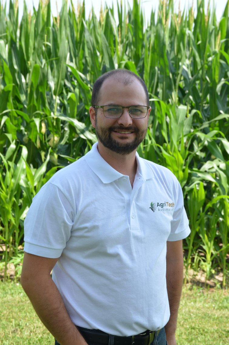 Patrick Longo, co-founder of AgriTech Automation, standing in front of a corn field